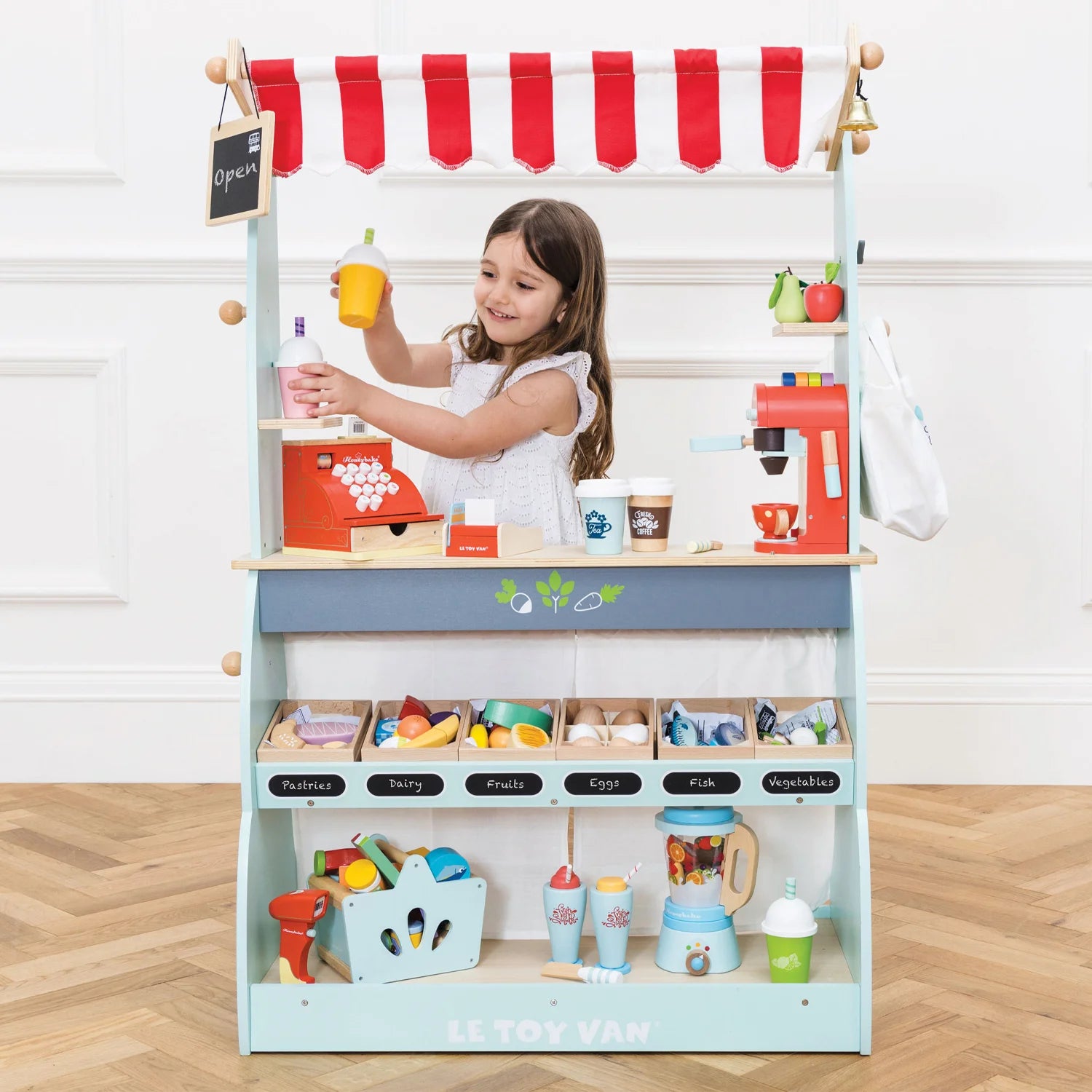 Children playing with wooden fruit set.