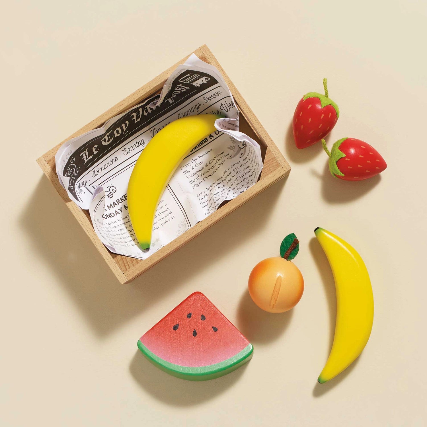 Colorful wooden fruits including banana and strawberries.