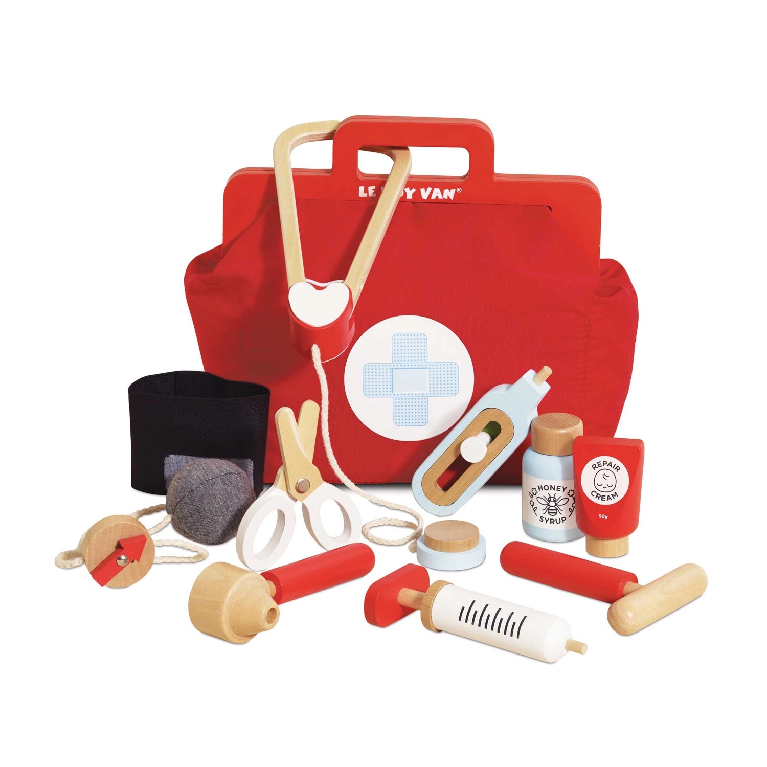 Red toy first aid kit with various medical tools on a white background