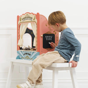 Tabletop puppet theatre with chalkboard and curtains.