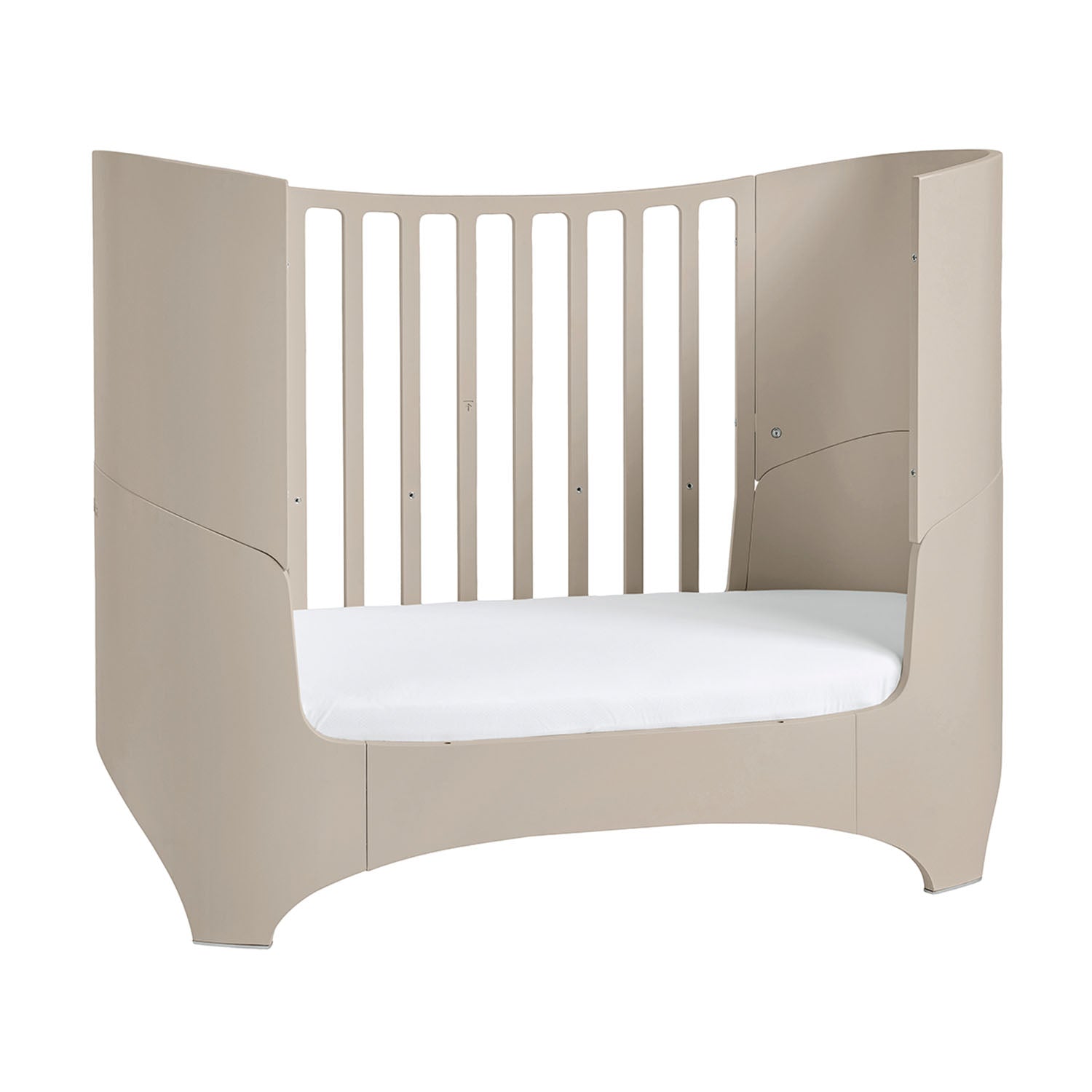 Baby cot with lowered mattress base for growing toddler.