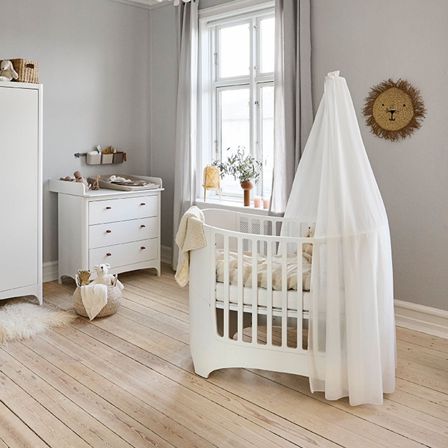 Oval Leander Classic cot positioned beside a nursery window.