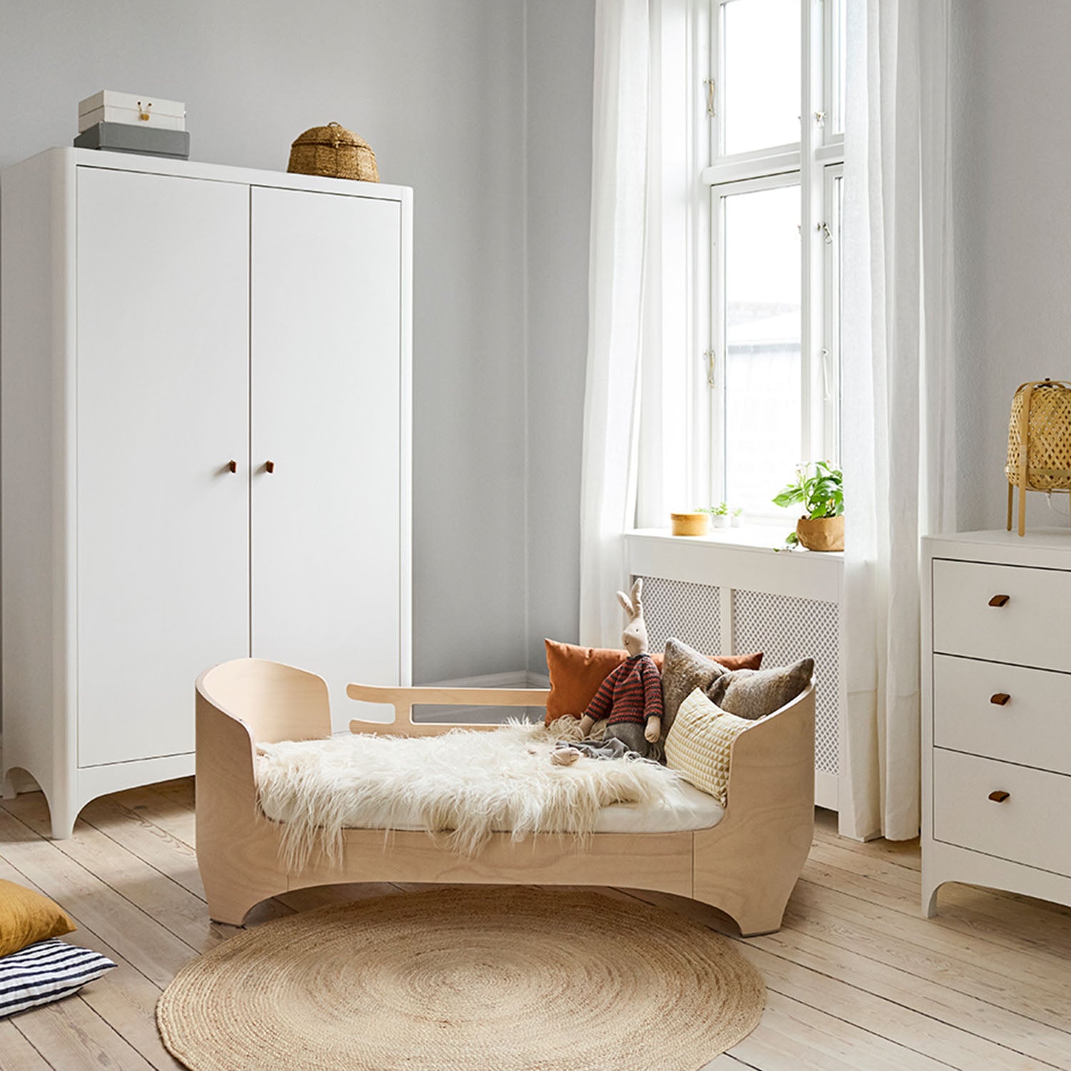 Bright nursery interior centered around Leander baby bed.