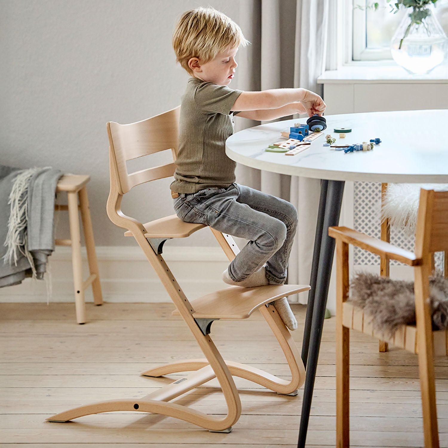 Adjustable seat and footplate of the Leander highchair for growing children..