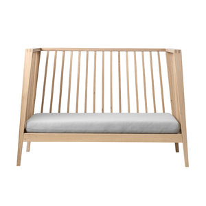 Leander Linea™ Baby Cot showing natural oak finish and design.