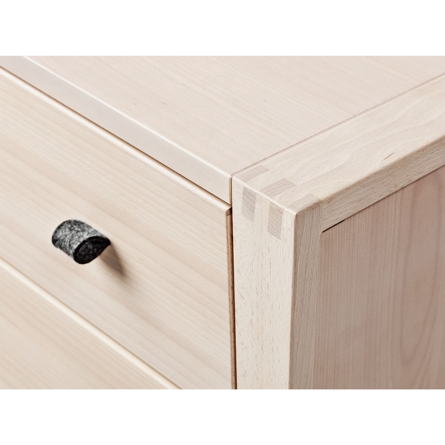 Close view of drawer handles and smoth corner.