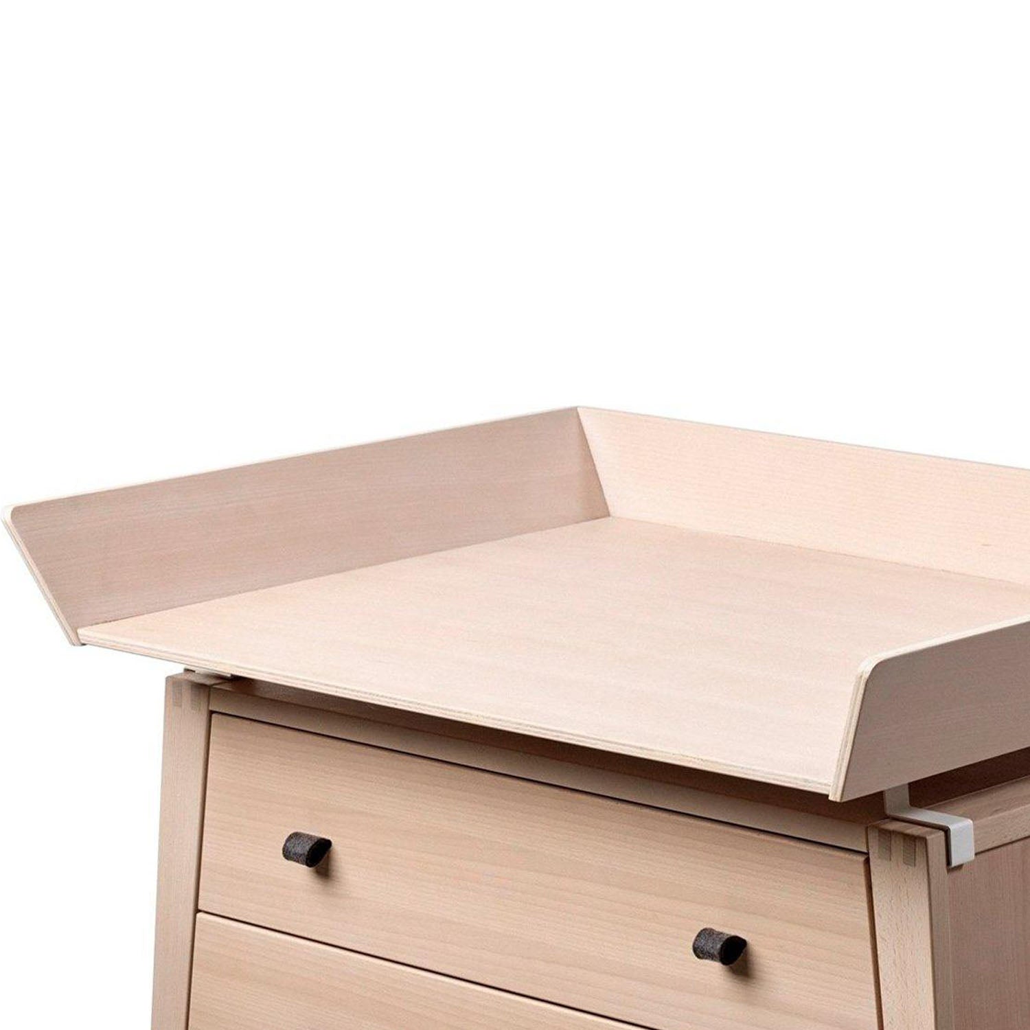 Top view of changing unit fitted securely on dresser