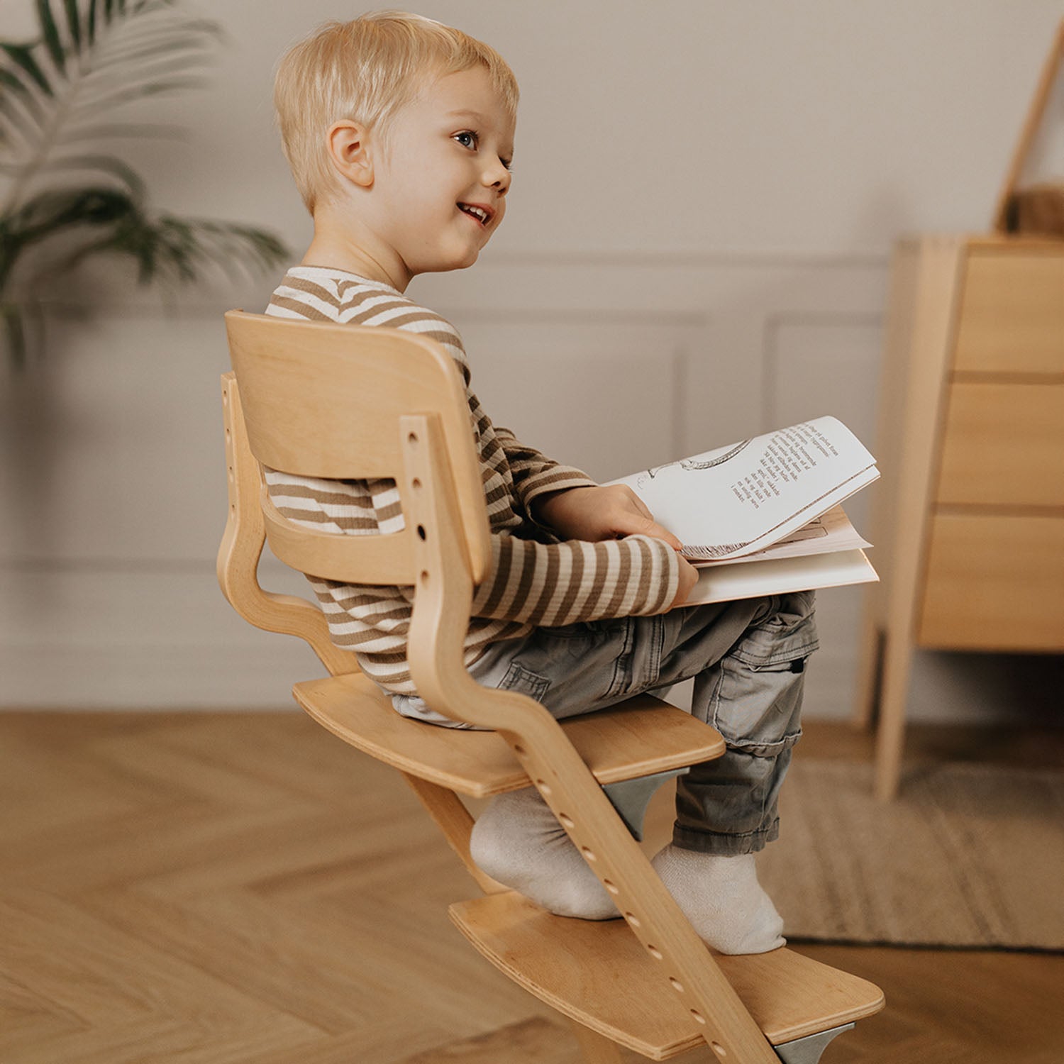 The chair adjusted for a young child, with the footrest lowered to accommodate longer legs, providing ergonomic seating for crafts, homework, or dining.