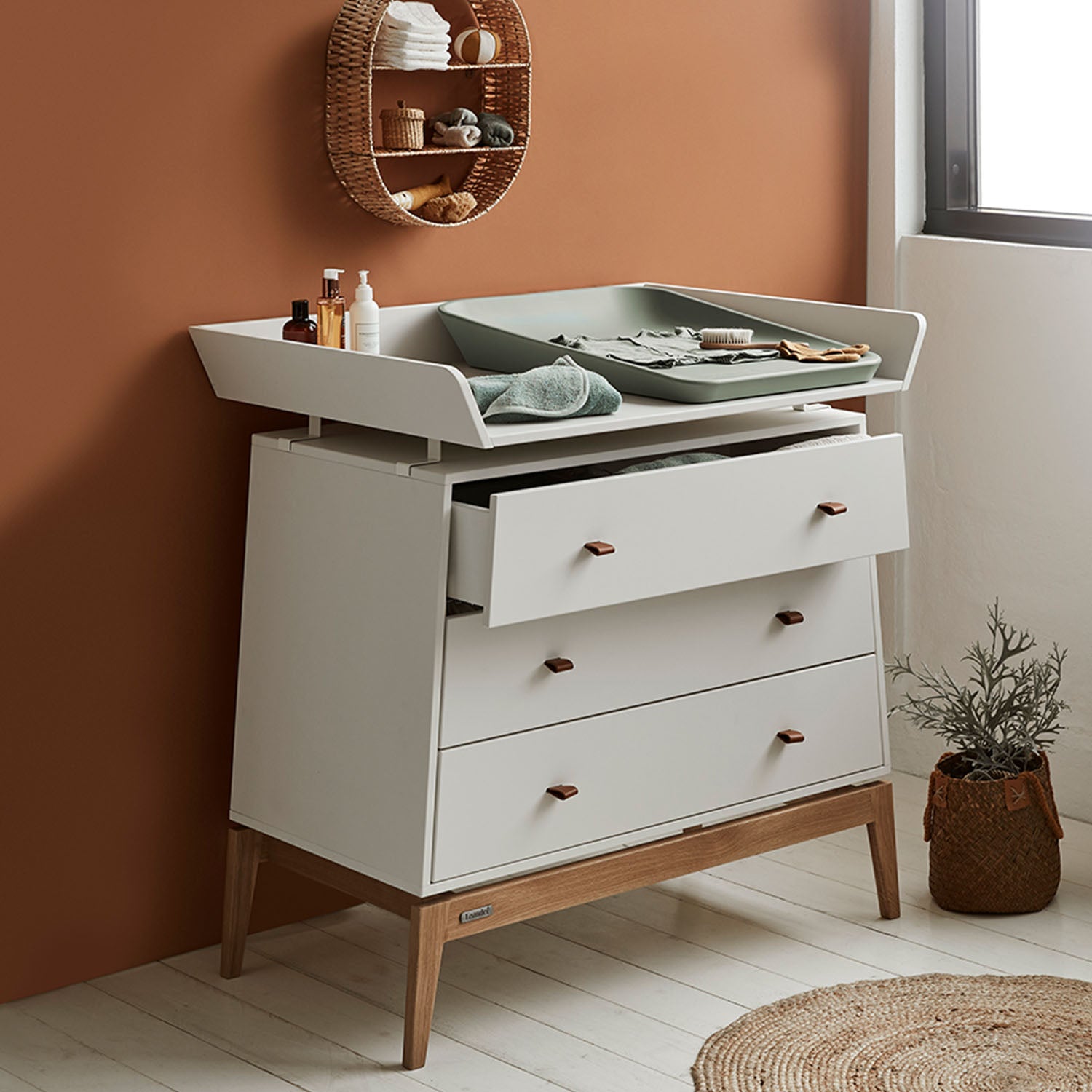 Leander Luna™ changing unit attached securely on top of the dresser.