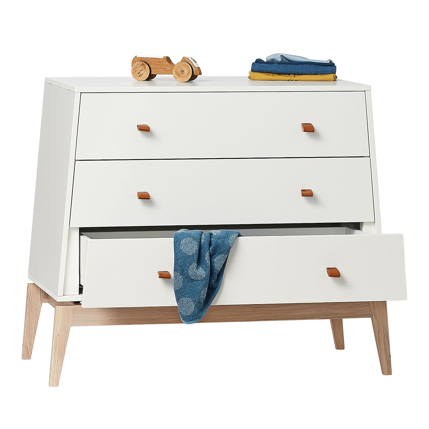 Close-up of soft leather drawer handles on the dresser.