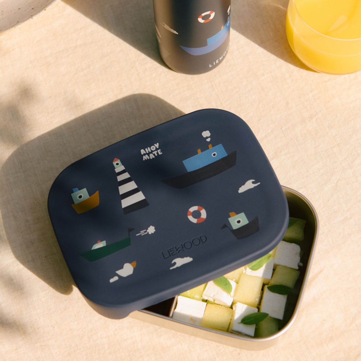 Half closed lunchbox featuring a playful print on the soft lid.