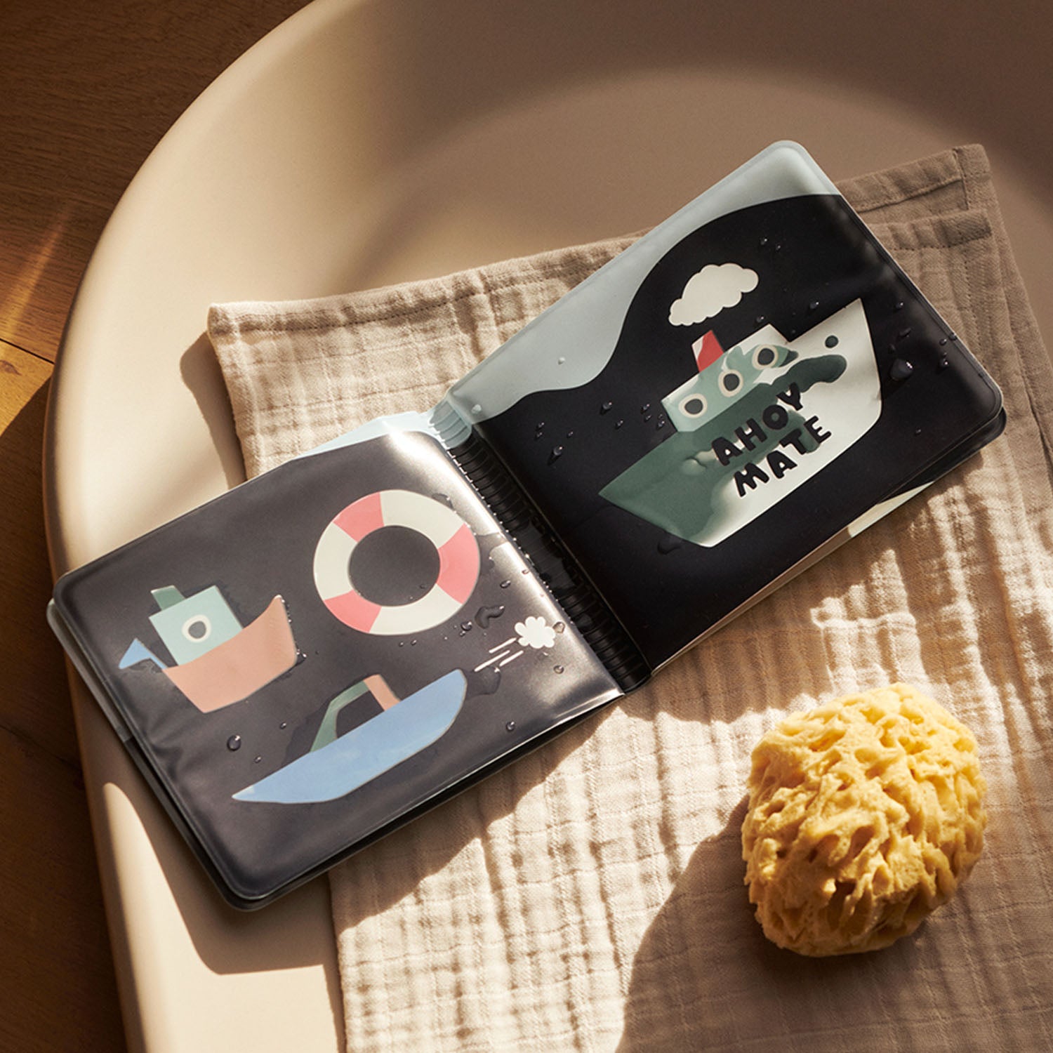 Open bath book showing color-changing ship illustrations.