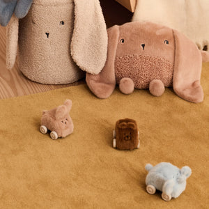 Liewood Ansel plush car set arranged with matching soft neutral-toned nursery accessories