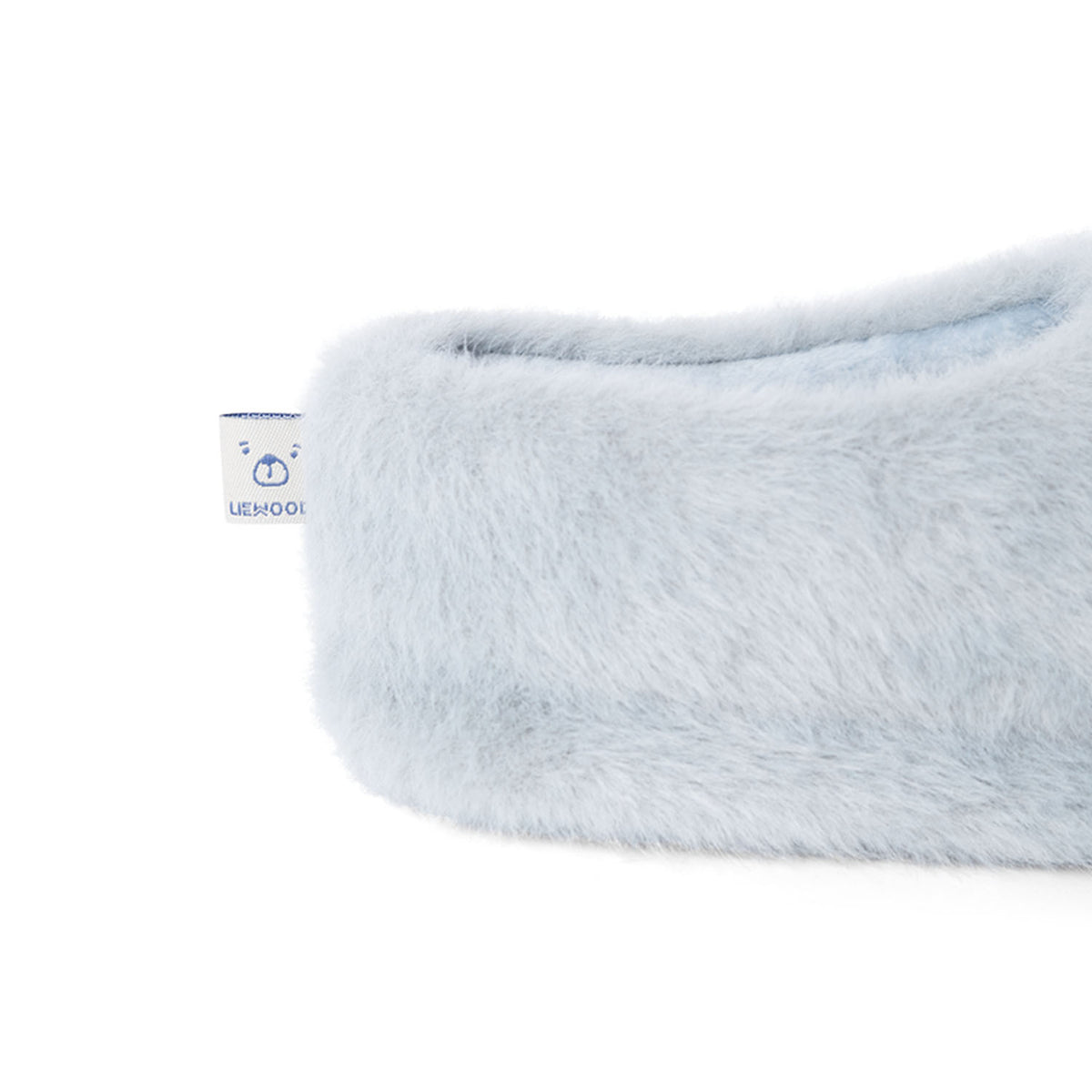 A close-up view of the heel of the dove blue Liewood Aviaja bear slipper, showing the fluffy recycled polyester material and a small brand tag.