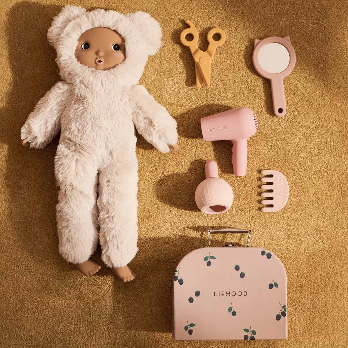 Doll with Liewood Ellery hairdressing set, showing pretend play salon setup