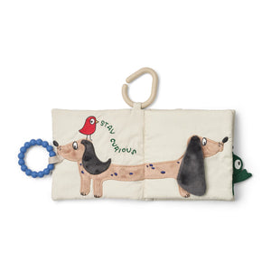 Open soft book showing illustrated animal character and sensory fabric page with blue teether ring