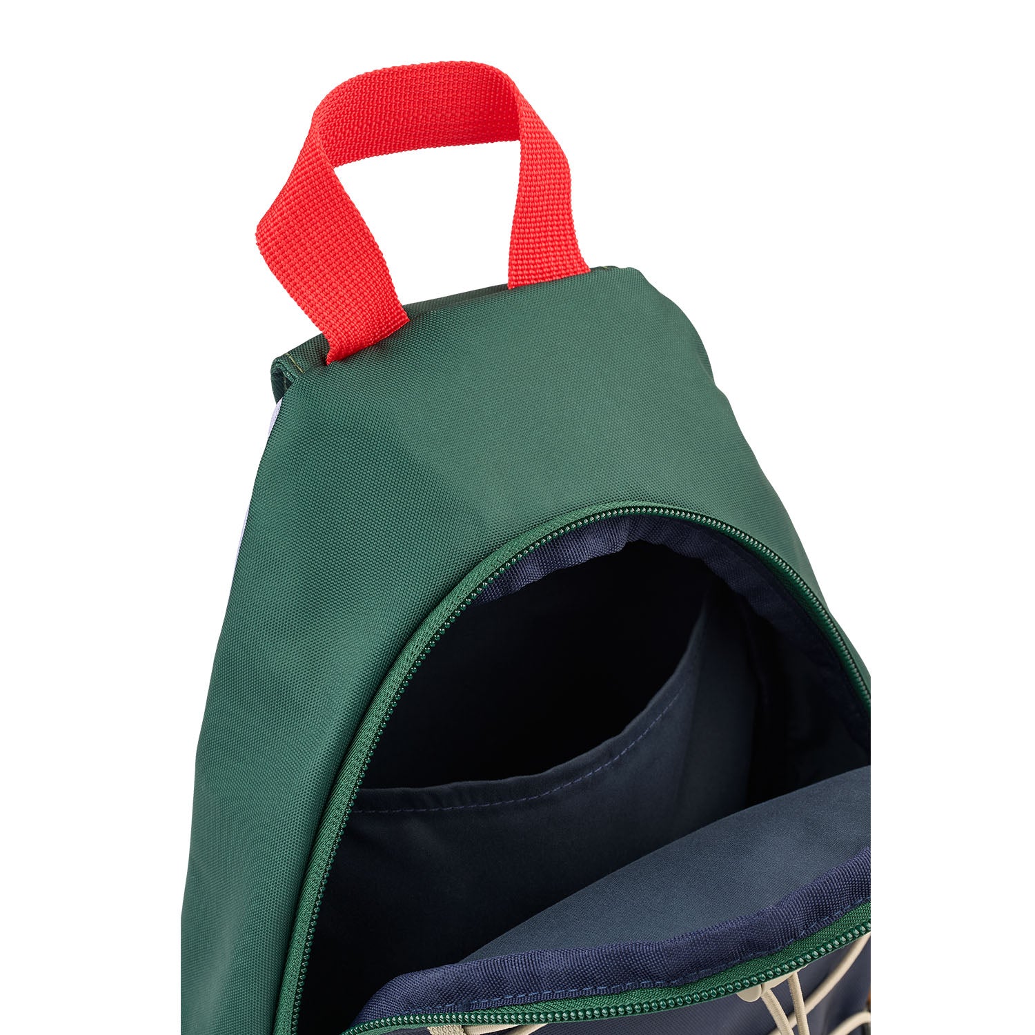 Close up view of an open Liewood green and navy colorblock sling backpack showing the inside pocket and a red top handle