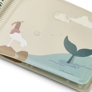 Close-up of Liewood Waylon bath book page showing whale design and sandy colour scheme