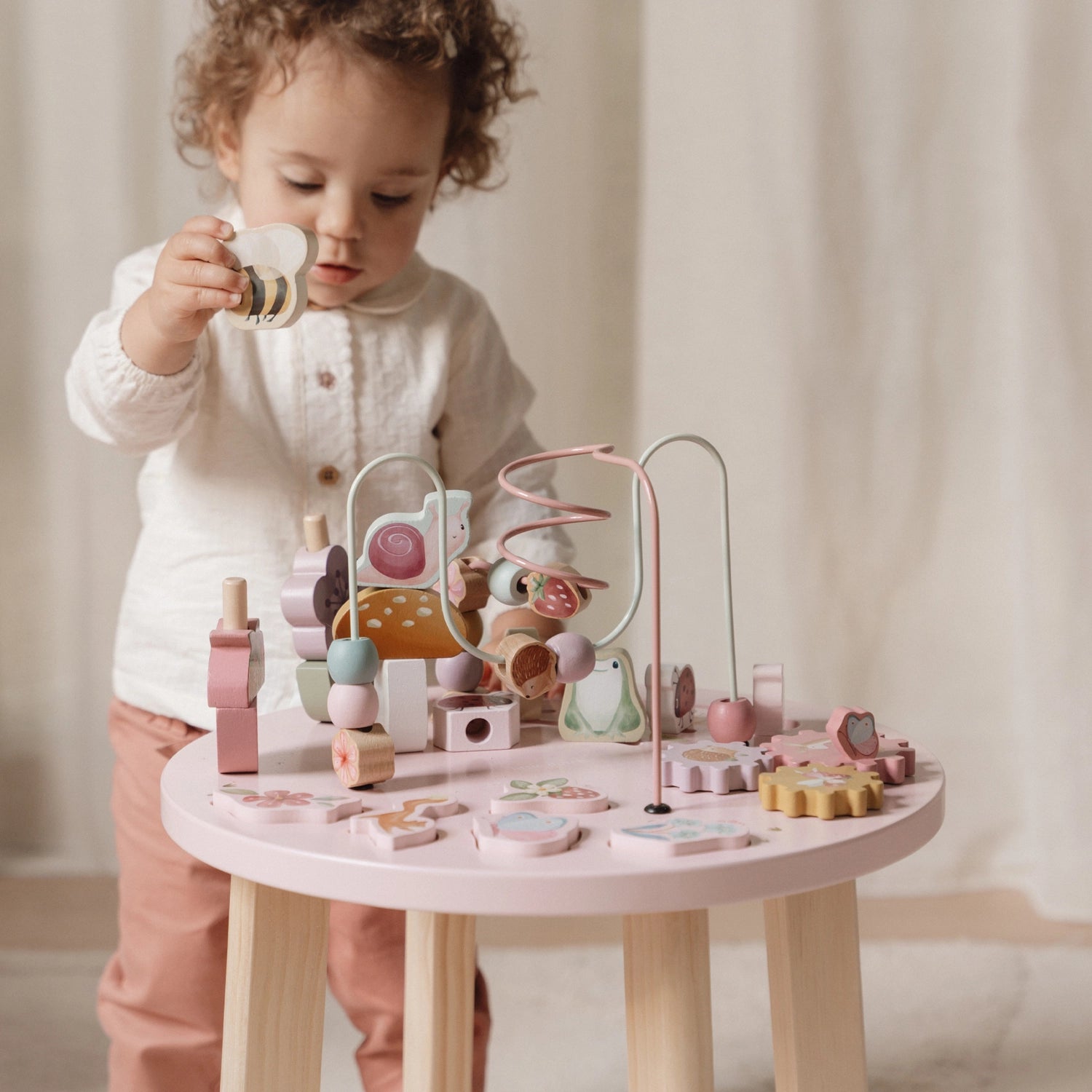 Kids playing with flowers on activity table