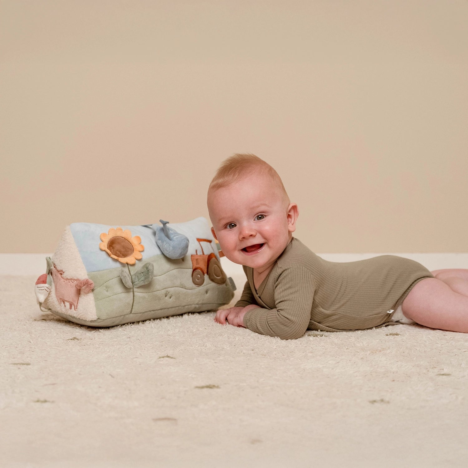 baby playing with colorful little dutch activity triangle.