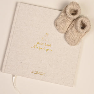 Light beige linen cover of Little Dutch Baby Book 'My First Year' with Baby Bunny illustration.