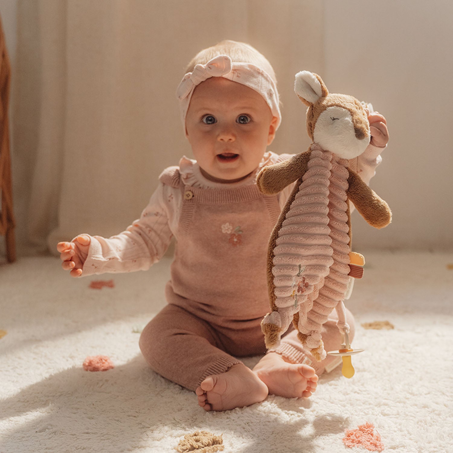 Infant holding Little Dutch deer comfort cloth.