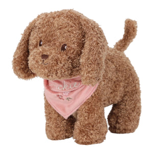 Brown plush dog toy with a pink bandana on a white background