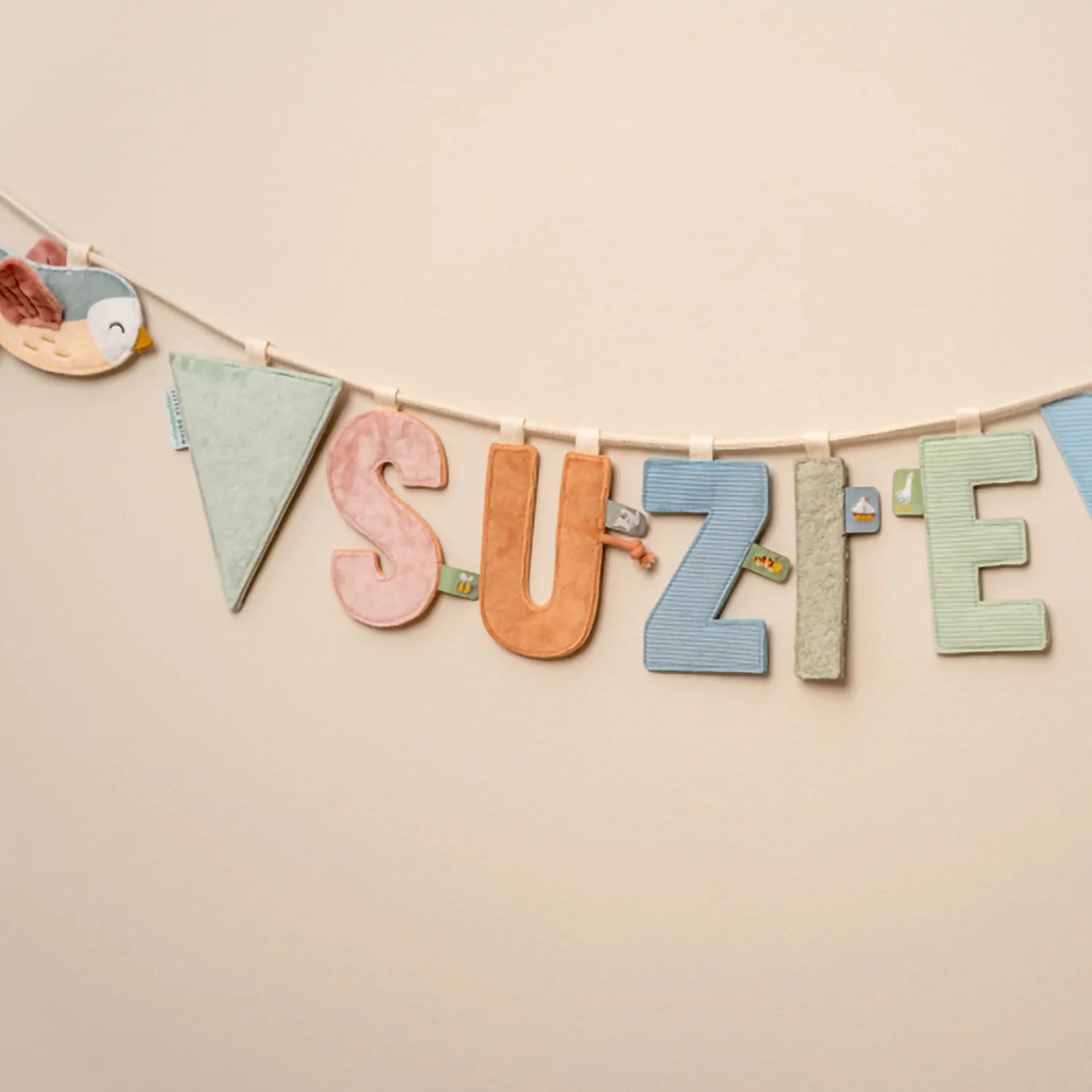 Garland assembled with letters and flags hanging on a wall.