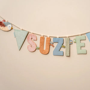 Garland assembled with letters and flags hanging on a wall.