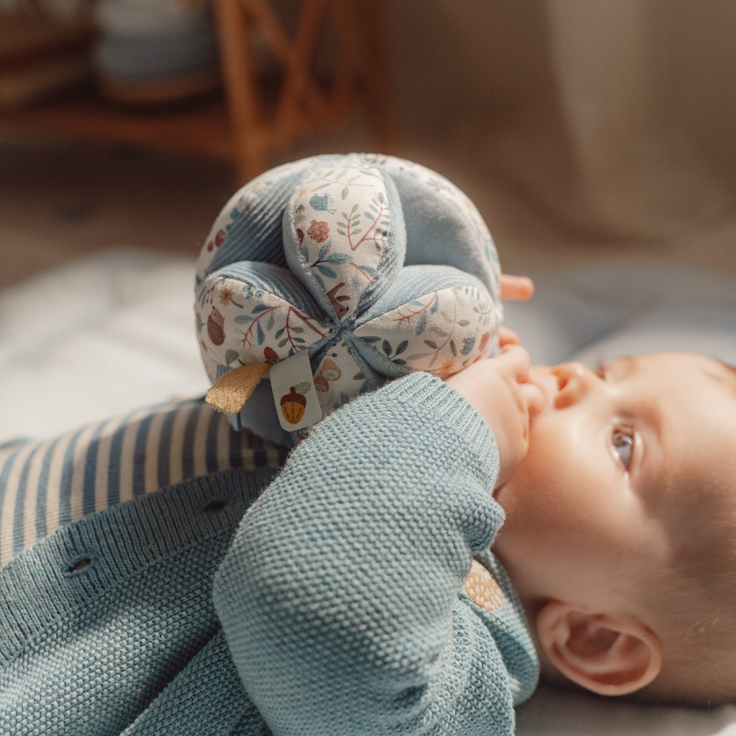 Baby is playing with the little dutch gripping ball.