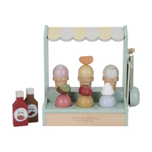 Wooden ice cream shop toy with three ice cream cones in different flavors, six ice cream scoops in various colors, four toppings, two sauce bottles, and a price list. The toy is in multicolor pastel shades.