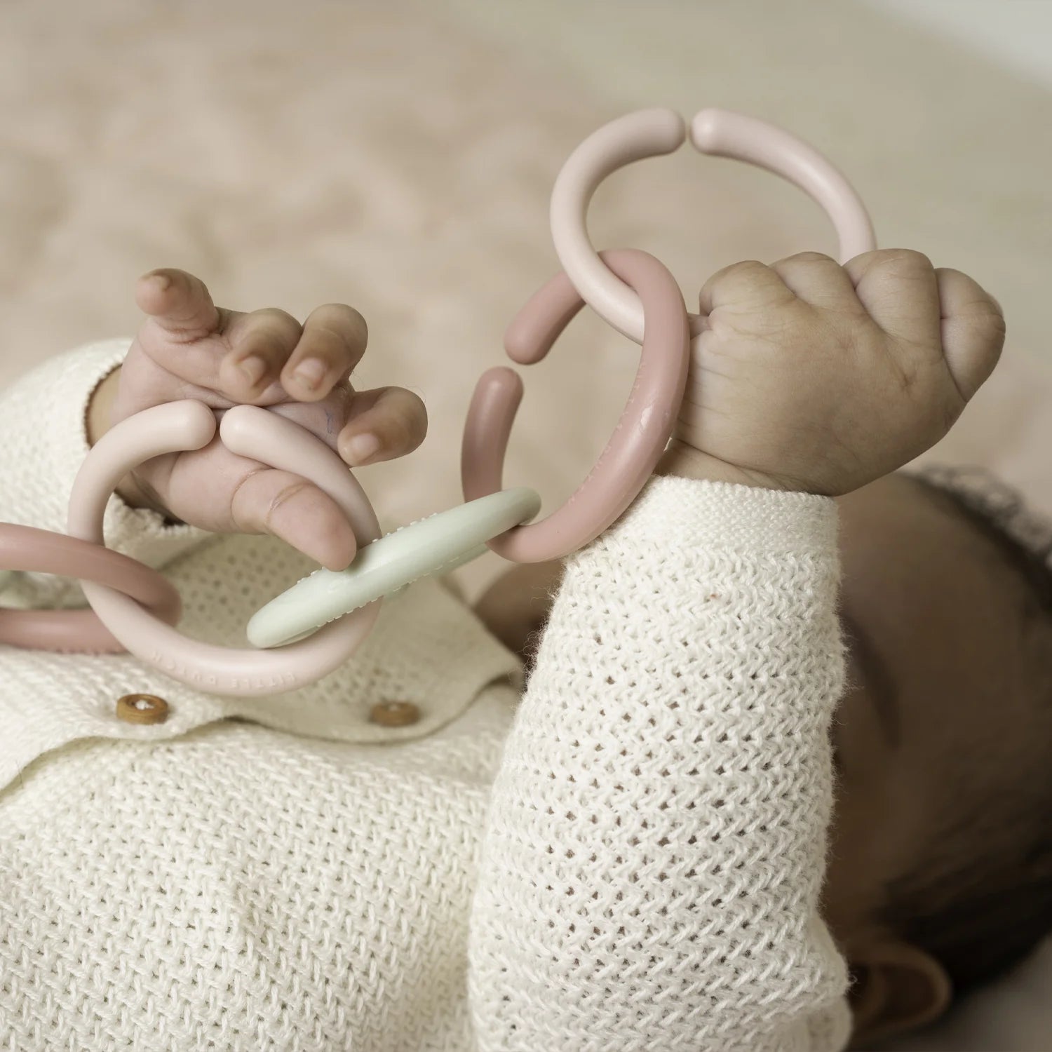 A baby is playing with the loop.