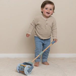 A baby boy is playing with Little Dutch rattle