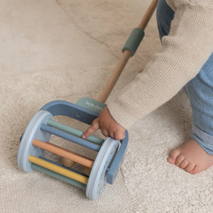 A toddler is playing with Little Dutch rattle