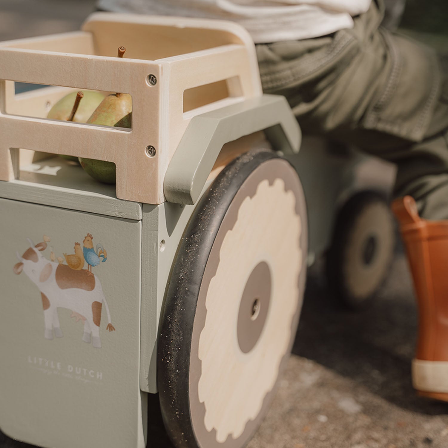 Little Dutch ride-on tractor with toy box at the back.