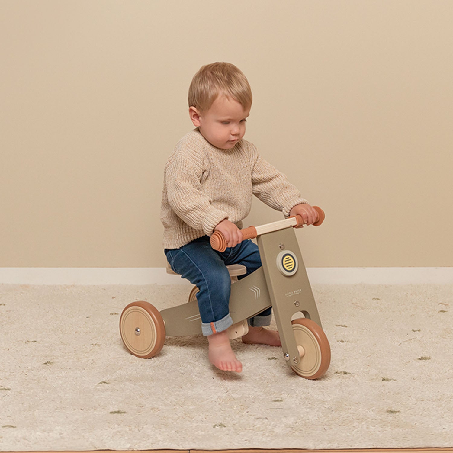 Child riding Little Dutch tricycle inside the house.