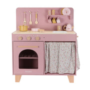 Pink toy kitchen set with various accessories on a white background