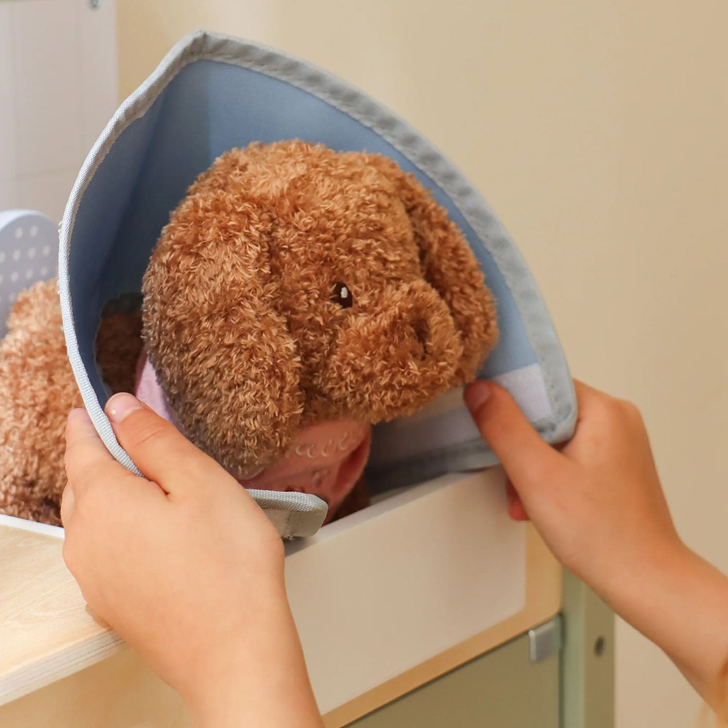 Pretend role-play scene with child caring for toy animals.