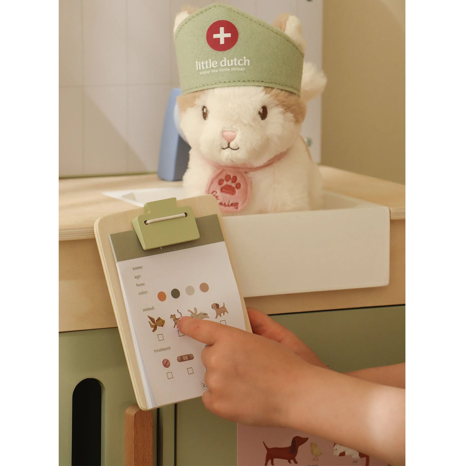 Little hands playing with accessories in the veterinary practice set.