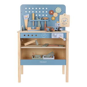 Wooden toy workbench with tools and a blue pegboard on a white background