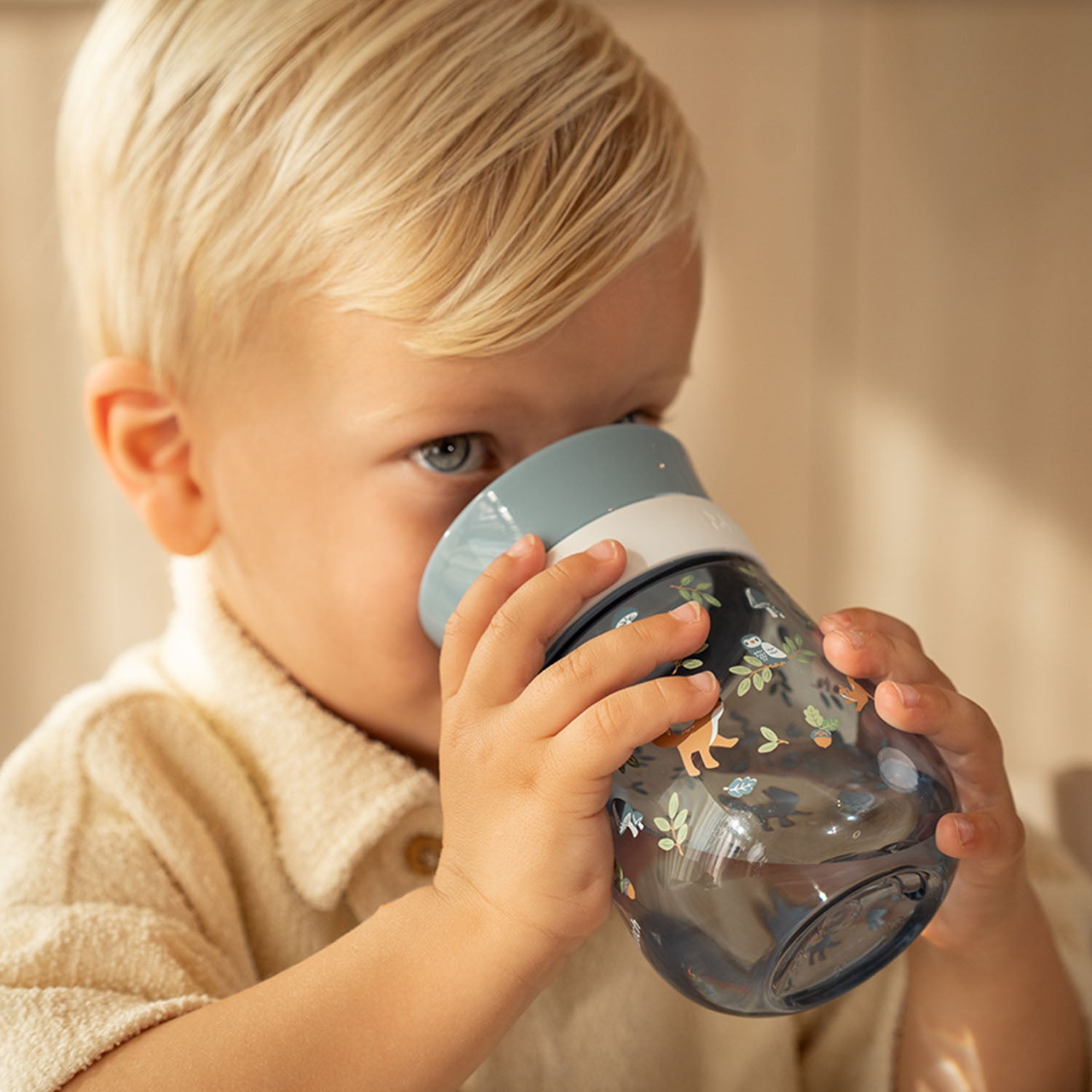 A young boy drinking independently from the Little Dutch 360-degree Forest Friends cup, demonstrating the easy-sip edge.