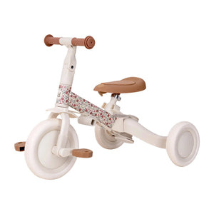 Side view of natural wood Little Dutch tricycle showing frame and wheels
