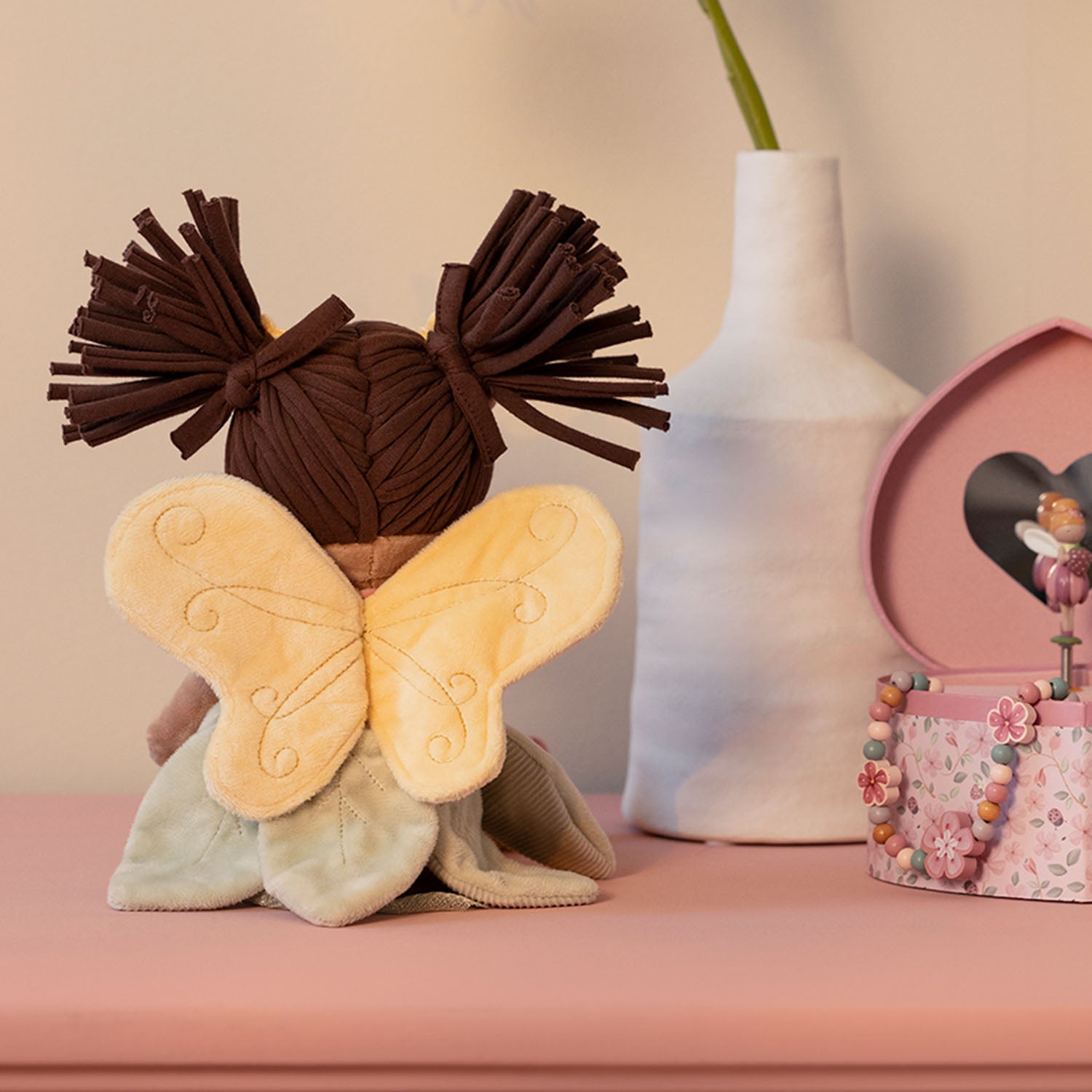 Cute fairy doll with wings and floral-inspired clothing for nursery decor