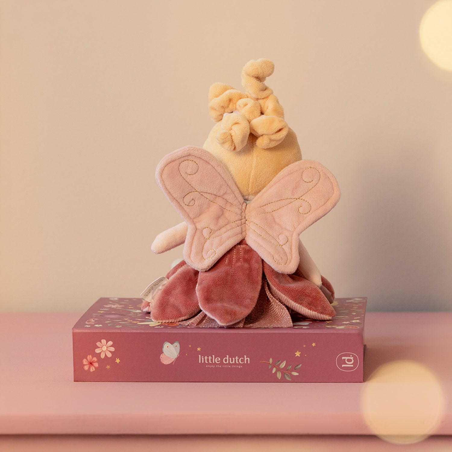 Whimsical fabric wings attached to the back of the doll for a magical look.