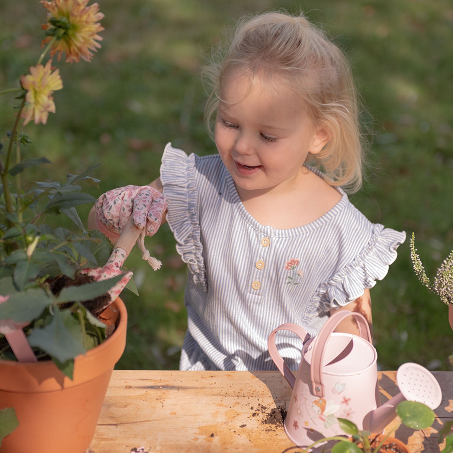 A girl is enjoying creative outdoor activities.