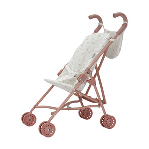 Angled view of the Little Dutch metal doll stroller featuring a pink frame, pink wheels, and a patterned light-colored fabric seat.