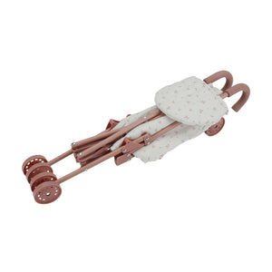 The Little Dutch doll stroller completely collapsed and folded flat to demonstrate its easy-fold design for storage.