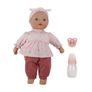 Little Dutch Baby Lily doll sitting on a white background, displayed alongside its included pink pacifier and milk bottle accessories.