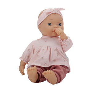 Side-angle view of the Little Dutch Baby Lily doll sitting by itself on a white background.