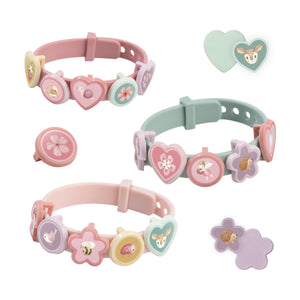 3 Little dutch slide charm bracelets in pastel pink and green, decorated with interchangeable flower, heart, and butterfly charms on a plain white background.